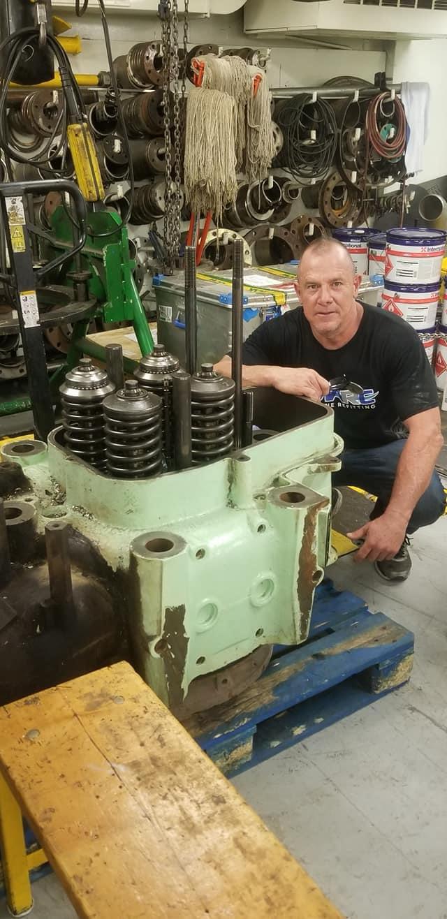 Jason working beside an engine block in Italy